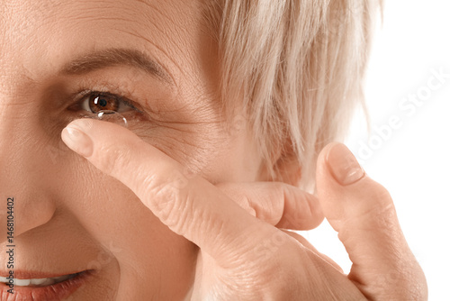 Mature woman putting in con...