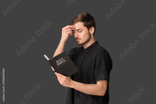 Man with Holy Bible praying...