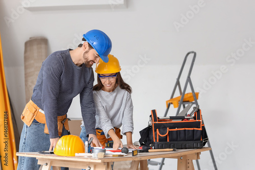 Young couple with plan at t...