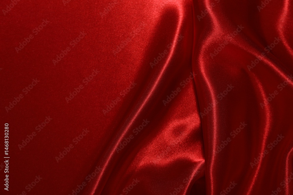 Red crumpled silk fabric as background, top view