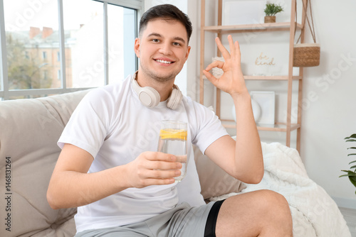 Sporty young man with glass...