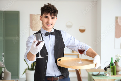 Male waiter holding tray wi...