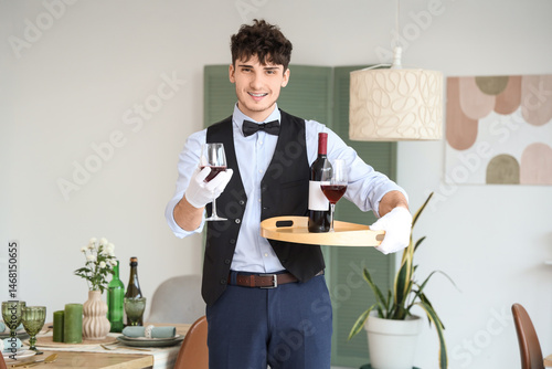 Male waiter holding tray wi...