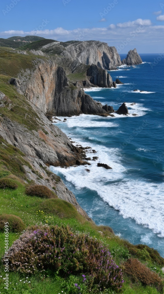 Coastal Cliffs and Blue Sea: Rugged Rocks, Green Grass, and Ocean Waves Under a Sunny Sky Coastal Cliffs and Blue Sea: Rugged Rocks, Green Grass, and Ocean Waves Under a Sunny Sky