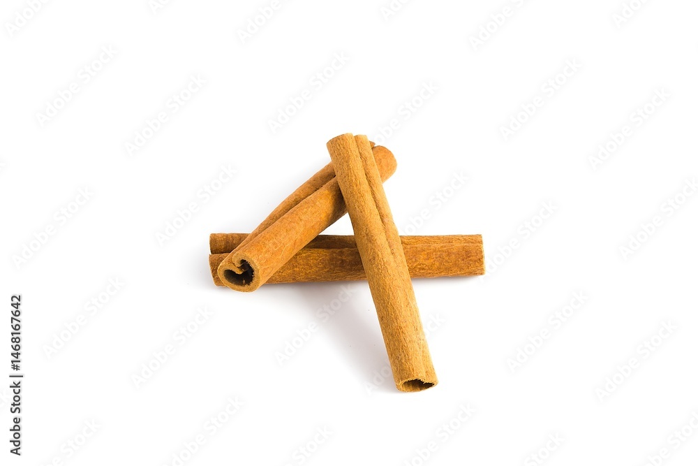 Scattered cinnamon bark pieces on a white surface, capturing their rustic texture and deep brown shades. Scattered cinnamon bark pieces on a white surface, capturing their rustic texture and deep brown shades.