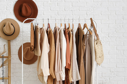 Rack with stylish clothes a...