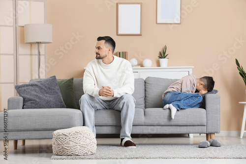 Father with his crying son ...