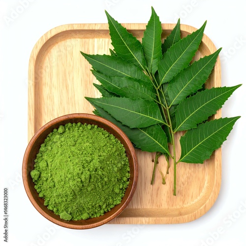 Fresh neem leaves and powder displayed on a wooden tray, highlighting natural remedies.