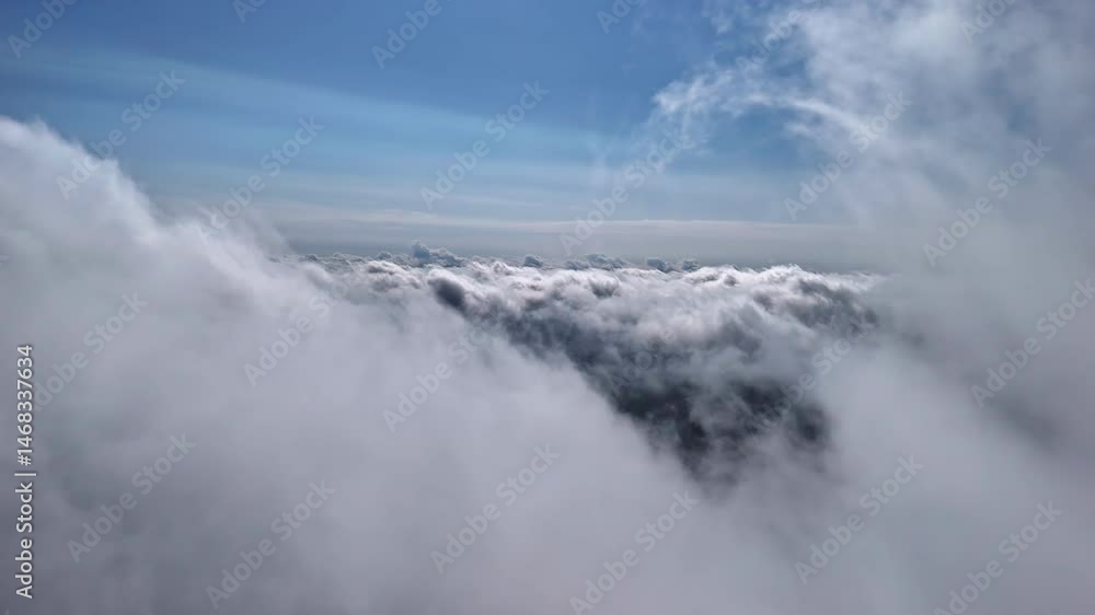 High-altitude drone captures thick white clouds with a view toward the horizon and deep blue sky High-altitude drone captures thick white clouds with a view toward the horizon and deep blue sky
