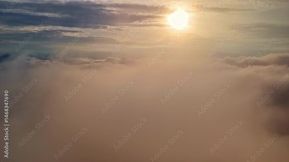 Sun shining over thick clouds layer during scenic sunset Sun shining over thick clouds layer during scenic sunset