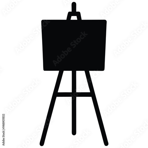 A simple black easel displays an artist's canvas ready for creative expression