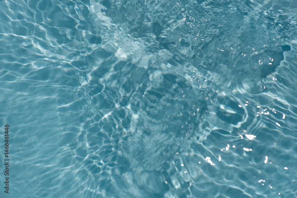 Blue water with ripples on the surface. Defocus blurred transparent blue colored clear calm water surface texture with splashes and bubbles. Water waves with shining pattern texture background. Blue water with ripples on the surface. Defocus blurred transparent blue colored clear calm water surface texture with splashes and bubbles. Water waves with shining pattern texture background.