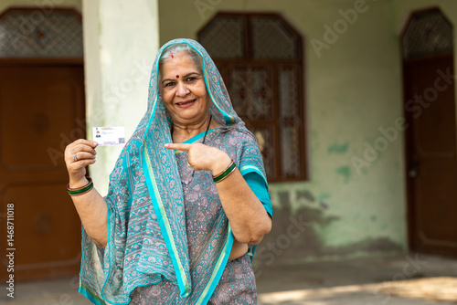 Photography Portrait of Indian old woman showing showing unique identity card at village