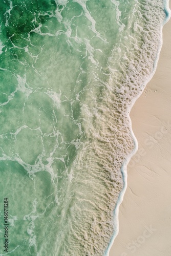 Serene ocean wave meeting pristine beach sand