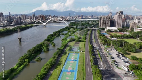 Aerial view on a beautiful sunny day above Crescent Bridge, which is a landmark pedestrian and cyclist bridge spanning Dahan river between Banqiao and Xinzhuang Districts in New Taipei City, Taiwan