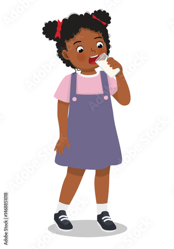 Little African girl drinking a glass of milk