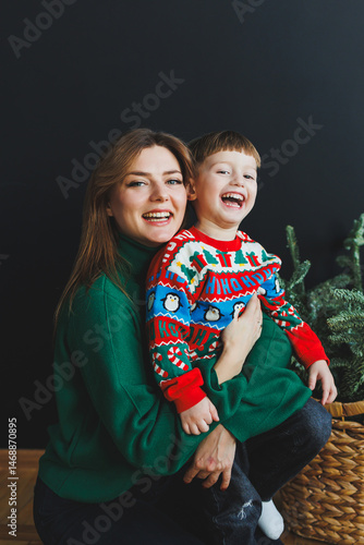 Obraz na płótnie Mom spends time with her son on New Year's Eve at home. Holiday games of mom with son at home. Cheerful childhood. w salonie