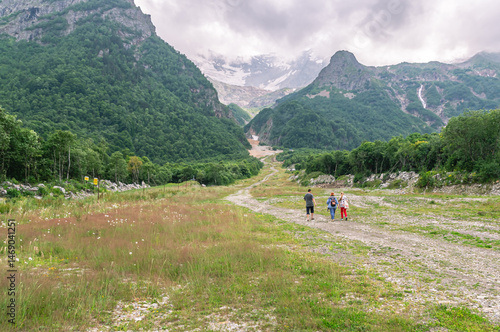 Family vacation in the mountains. Hiking in the mountains. A group of people is traveling high in the mountains. Vacation in the mountains.