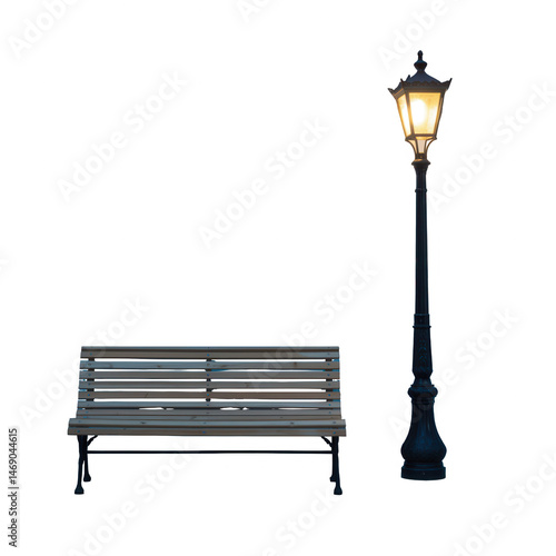 A park bench sits next to a glowing street lamp illuminating the dark night with its soft light