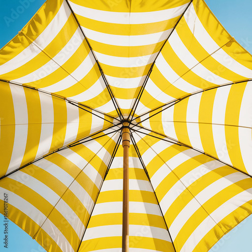 Yellow and White Striped Beach Umbrella Under Sunny Sky