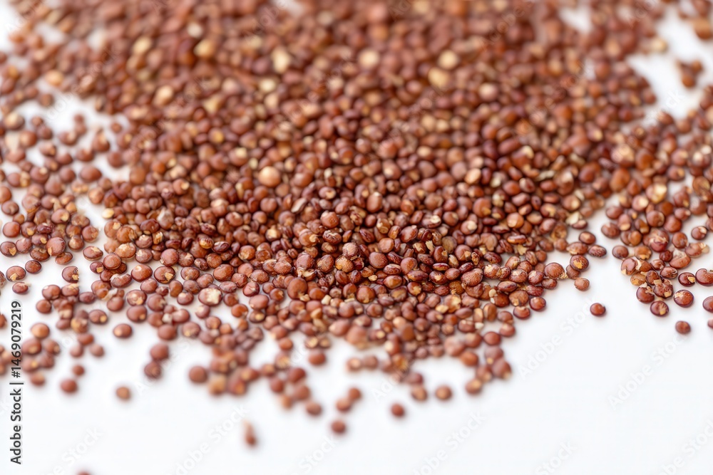 Close-up of red quinoa grains scattered on white background
Close-up of red quinoa grains scattered on white background