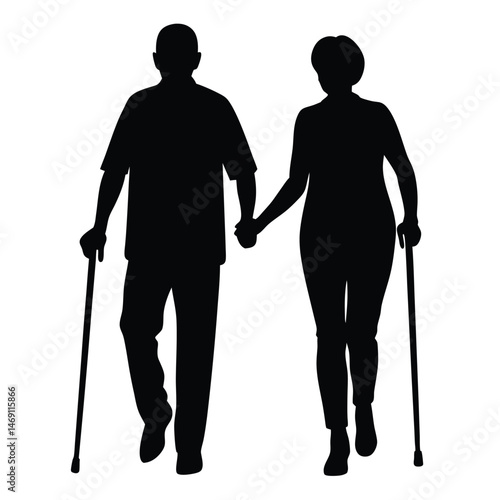 Elderly African American couple holds hands and walks with canes in this silhouette
