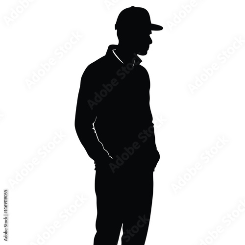 Silhouetted man wearing cap and jacket appears pensive with hands in his pockets