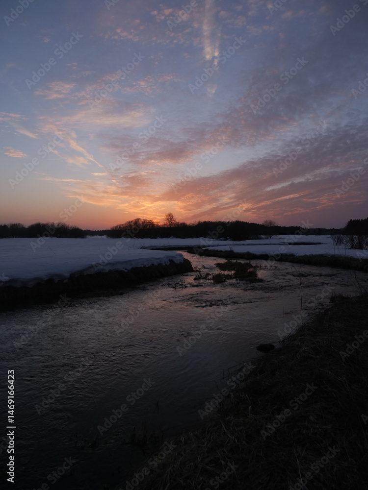 Fototapeta premium A river with a sunset in the background