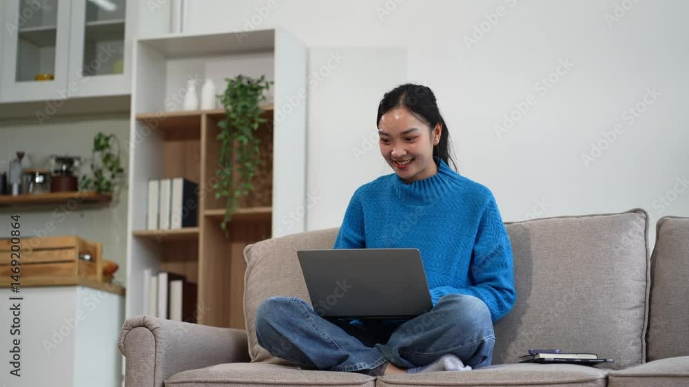 Happy woman having fun doing video call using Laptop computer sitting on sofa. Happy woman having fun doing video call using Laptop computer sitting on sofa.