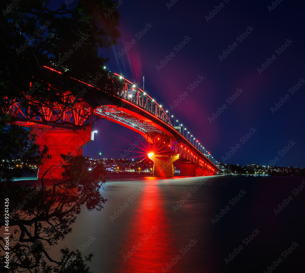 Auckland Harbour Bridge glowing in red lights. Auckland. New Zealand.