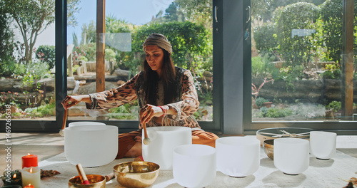 Woman, sound therapy and healing with naturopath with bowls, ceremony and culture in studio. Female healer, ritual and aromatherapy for Buddhism with herbal remedy or natural vibration with homeopath