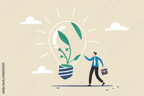 Ecology and sustainable business, green idea or protection against world climate change, environmental care concept, smart businessman watering seedling sprout growing inside green lightbulb idea.