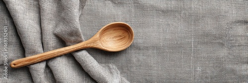 Obraz na płótnie Wooden Spoon Rests on a Textured Linen Kitchen Towel Creating a Cozy Cooking Atmosphere in a Well-Organized Kitchen Space Generative AI w salonie