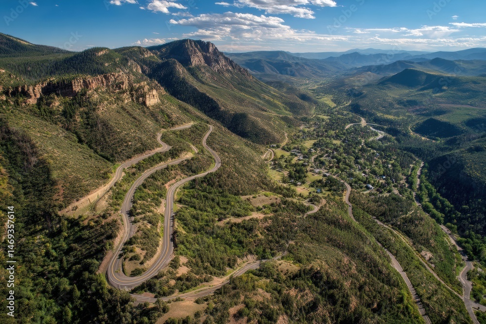 Scenic Switchback Road Winds Through Lush Mountains in Summer Landscape Under Blue Skies Generative AI