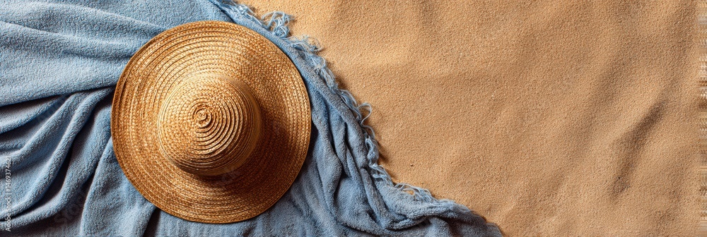Floppy Sunhat Resting on a Towel With Soft Sand Surrounding It at a Sunny Beach Location Generative AI