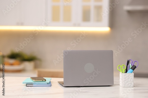 Wallpaper Mural Laptop, smartphone and stationery on white marble table in kitchen Torontodigital.ca