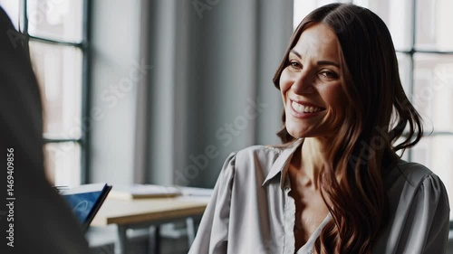 Engaging interview conversation with smiling woman in modern office setting