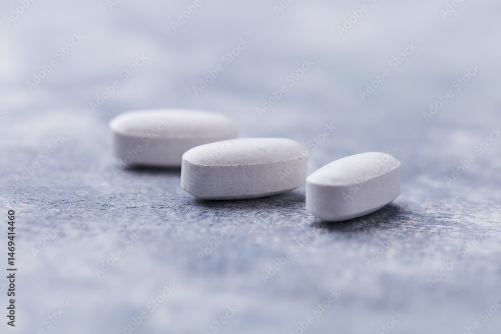 Amino acids tablets on wooden background. Soft focus. Close up Amino acids tablets on wooden background. Soft focus. Close up