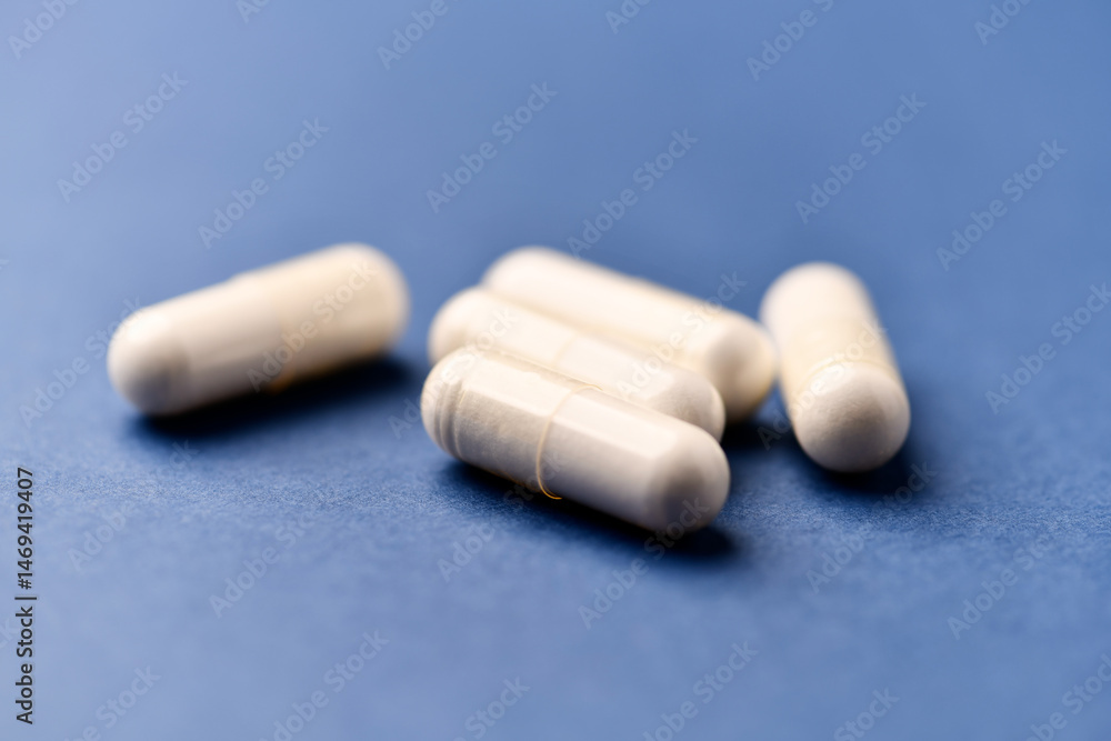 Arginine capsules on bright background. Soft focus. Close up. Copy space. Arginine capsules on bright background. Soft focus. Close up. Copy space.
