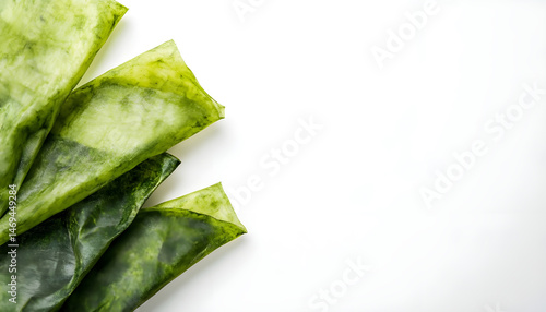 Green beeswax food wraps on white background, top view. Banner design