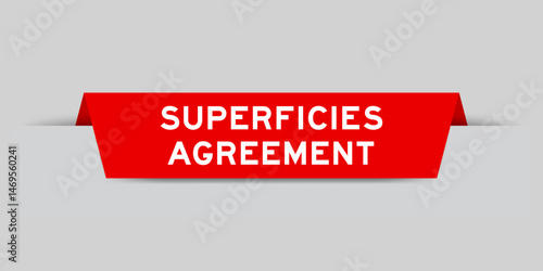 Red color inserted label with word superficies agreement on gray background