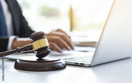 Judge gavel and laptop in law office setting