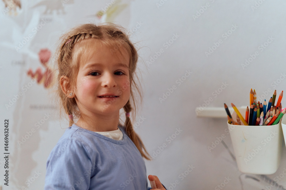 Fototapeta premium Girl Drawing in the Warmth of Her Room, Expressing Creativity and Imagination.