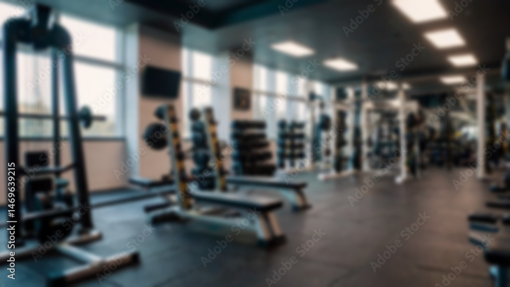 Fototapeta premium Abstract blurred fitness center with equipment as background, modern theme with complete equipment, bright light, blurred gym background.