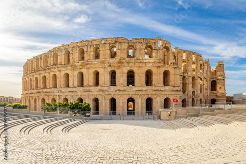 Ancient african Roman Colosseum amphitheatre arena panorama with tunisian flag at the entrance, El Jem, Mahdia, Tunis
