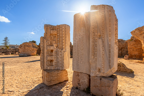 Sunlit ruins and stones with Roman inscriptions throwing shadows, Baths of Antoninus, ancient Carthage, Tunis, Tunisia