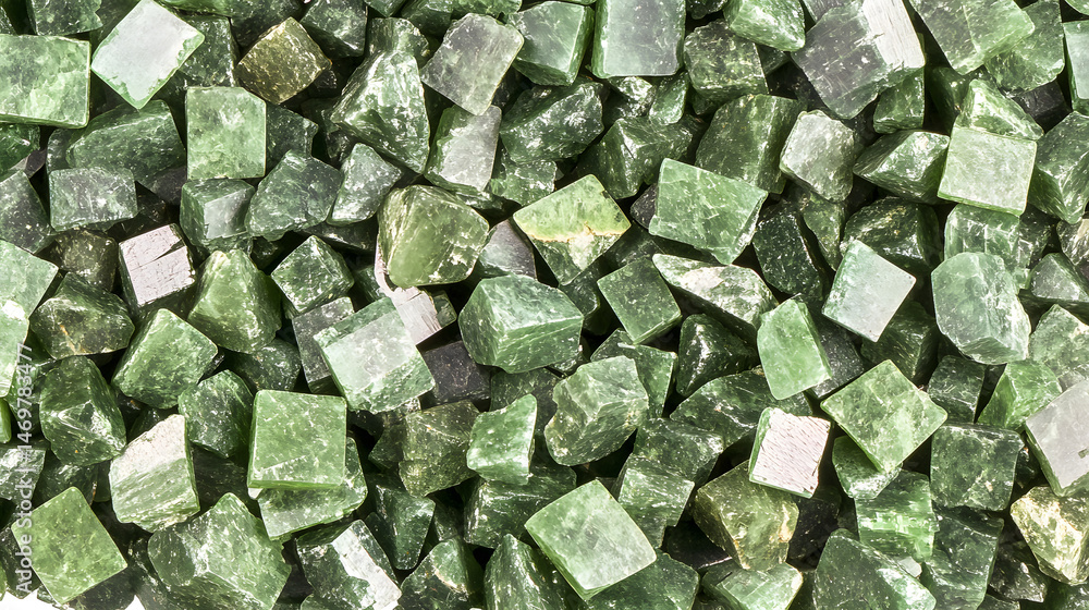 Fototapeta premium Green Jade Chips Texture: Close-up shot of numerous small green jade chips, showcasing their varied shapes, textures, and subtle color variations. Perfect for backgrounds or design elements.