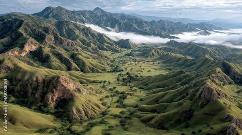 Aerial View of Mountain Ridge Surrounded by Early Morning Fog and Lush Green Landscape