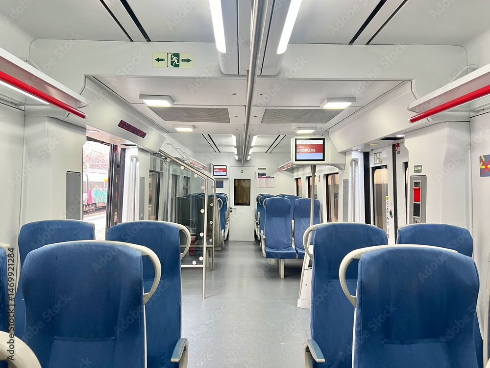 Naklejka premium Interior view of a modern train with empty blue seats and bright lighting