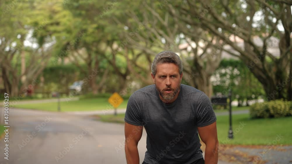 Tired mature Hispanic man runner stops to relax warming up his muscles after sport workout outdoor Tired mature Hispanic man runner stops to relax warming up his muscles after sport workout outdoor